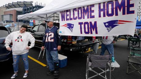 New England Patriots fans swing by a banner saluting Brady's return.