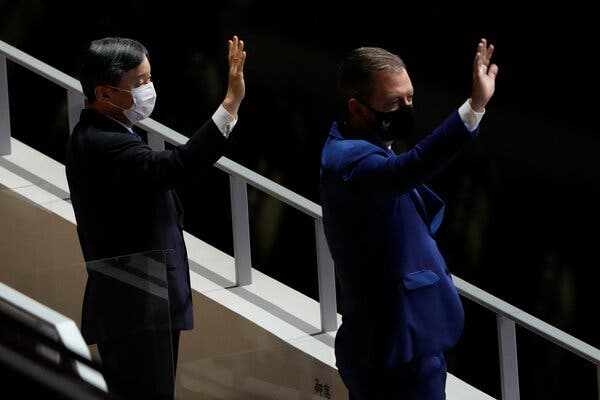 Japan's Emperor Naruhito, left, and Andrew Parsons, president of the International Paralympic Committee, waved during the start of the opening ceremony.