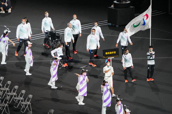 The Refugee Paralympics team leads the Parade of Nations to the Olympic Stadium during the opening ceremony of the Paralympic Games in Tokyo.