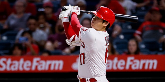 Los Angeles Angels batsman Shuhei Ohtani hits during a game against the Texas Rangers in Anaheim, California, September 4, 2021. (Associated Press)