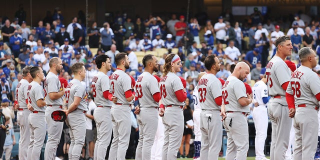 Louis Cardinals line up during pre-game celebrations for the National League Wild Card game between the St. Louis Cardinals and the Los Angeles Dodgers at Dodger Stadium on October 6, 2021 in Los Angeles, California.