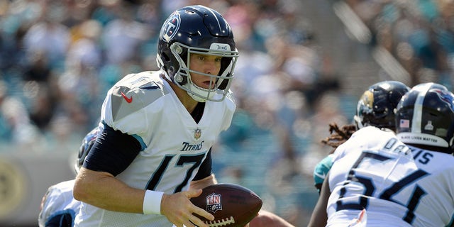 Tennessee Titans quarterback Ryan Tanehill (17) raises the ball during the first half of an NFL football game against the Tennessee Titans, Sunday, Oct. 10, 2021, in Jacksonville, Florida.