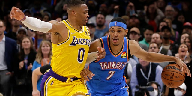 Oklahoma City Thunder's Darius Bazley (7) meets Los Angeles Lakers guard Russell Westbrook (0) during the second half of an NBA basketball game, Wednesday, Oct. 27, 2021, in Oklahoma City. 