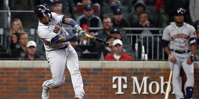 ATLANTA, GA - OCTOBER 31: Houston Astros #15 Martin Maldonado hits a RBI flyball against the Atlanta Braves during the second half of Game Five of the World Series at Truist Park on October 31, 2021 in Atlanta, Georgia.