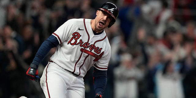 Atlanta Braves' Adam Duvall celebrates his Grand Slam race at home during the first inning of Game 5 of the World Baseball Championship between the Houston Astros and the Atlanta Braves Sunday, October 31, 2021, in Atlanta.