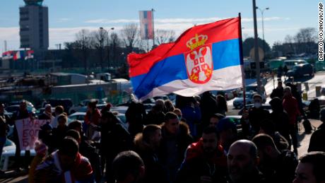Fans wave the Serbian flag upon Djokovic's arrival in Belgrade. 