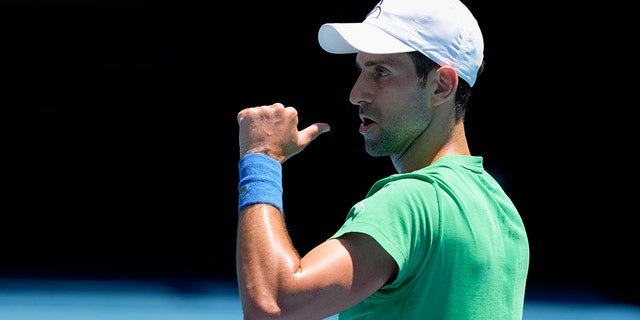 Defending champion Novak Djokovic of Serbia points during a practice session at the Margaret Court Arena ahead of the Australian Open tennis tournament in Melbourne, Australia, Thursday, January 13, 2022.