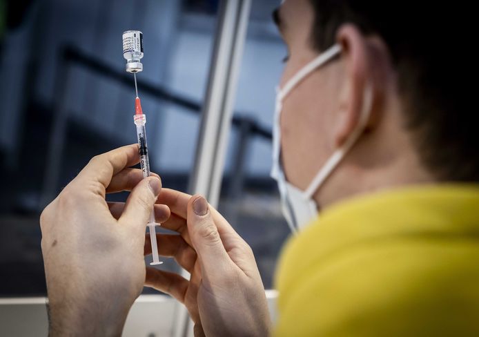 Staff prepare the Pfizer vaccine at the vaccination site at Schiphol Airport.