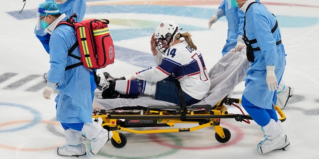 The United States' Brianna Decker is taken off the ice after being injured during a preliminary round women's hockey game against Finland at the 2022 Winter Olympics, Thursday, Feb.  3, 2022, in Beijing.