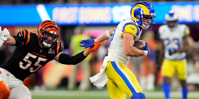 Cooper Cobb, right, of the Los Angeles Rams runs away from quarterback Logan Wilson, left, of the Cincinnati Bengals during the fourth quarter of an NFL Super Bowl LVI football game at SoFi Stadium in Inglewood, Sunday, February 13, 2022. 