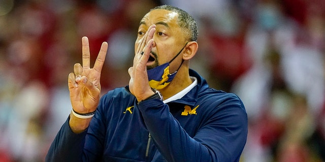 Michigan coach Joan Howard leads his team during the first half of an NCAA basketball game against Wisconsin on February 20, 2022, in Madison, Wisconsin, Wisconsin won 77-63.