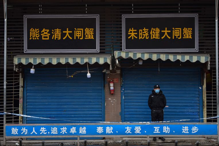 A security guard stands in front of a new market in Wuhan where the coronavirus was found, January 2020. Image AFP