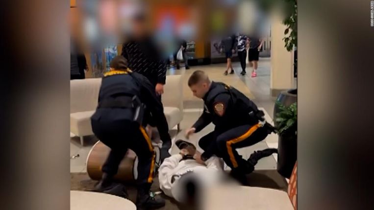Police officers hold the young black man to the ground.  statue 