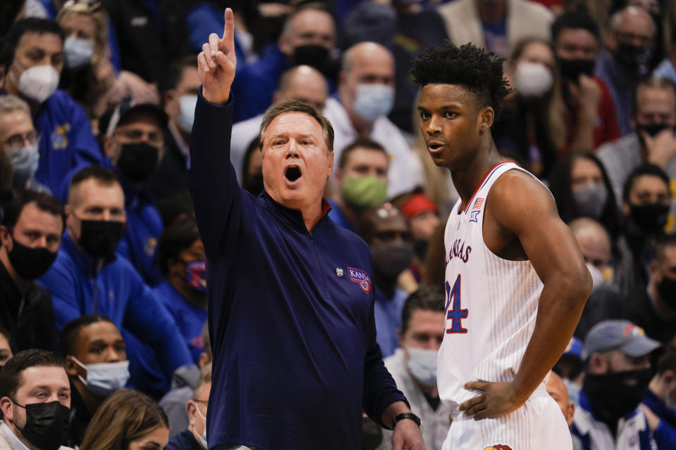 LAwrence, KS - FEBRUARY 12: Head coach Bill Self of the Kansas Jayhawks calls a play while speaking with KJ Adams #24 of the Kansas Jayhawks during their encounter with the Oklahoma Sooners during the first half at Allen Fieldhouse on February 12, 2022 in Lawrence, Kansas.  (Photo by Kyle Rivas/Getty Images)