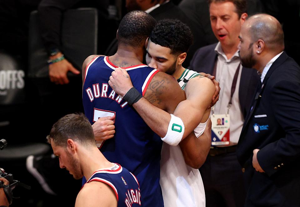 Kevin Durant of Brooklyn hugs and congratulates Boston's Jason Tatum after the Celtics netted in the first round of the NBA playoffs on April 25, 2022. (Elsa/Getty Images)