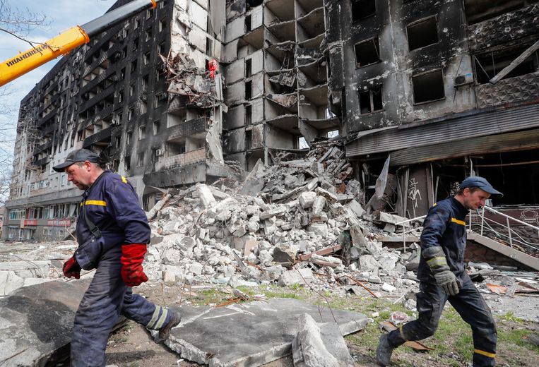 Rescue workers at a destroyed apartment building in Mariupol on April 10.  According to the city's mayor, 90 percent of it has been destroyed.  Reuters photo