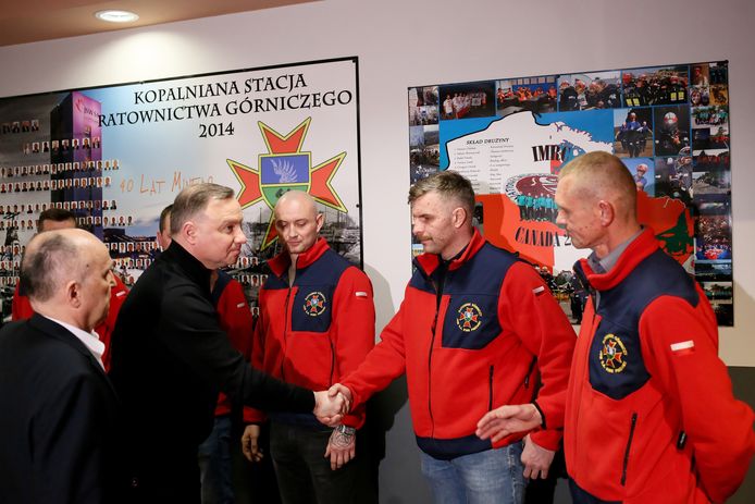 Polish President Andrzej Duda (second from left) and JSW CEO Tomasz Codney (left) meet rescue workers at the Pniowek Mine in Pawlowice.