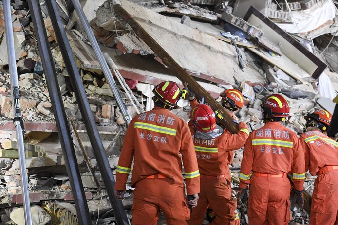 Rescuers search for victims under the rubble.