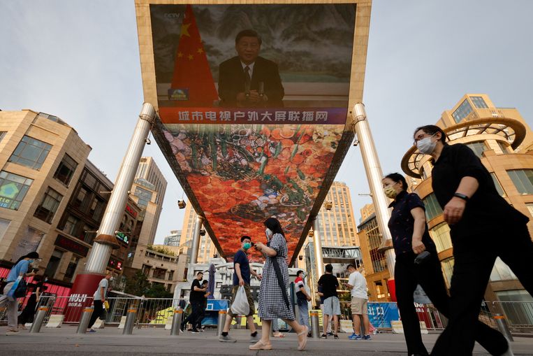 A screen in a shopping mall in Beijing shows a state media newscast on June 23 in which the Chinese president addresses the BRICS business forum via a video link.  Statue of Thomas Peter / Reuters