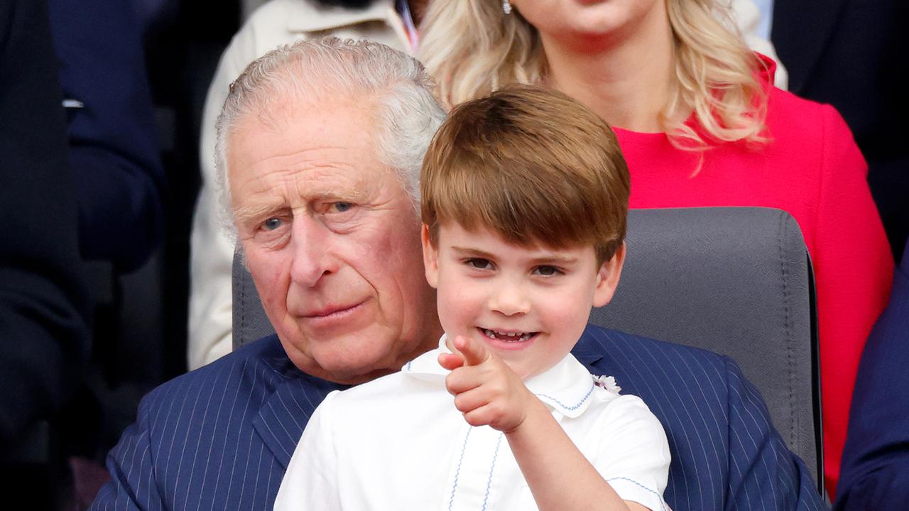 In the arms of grandfather, Prince Charles.