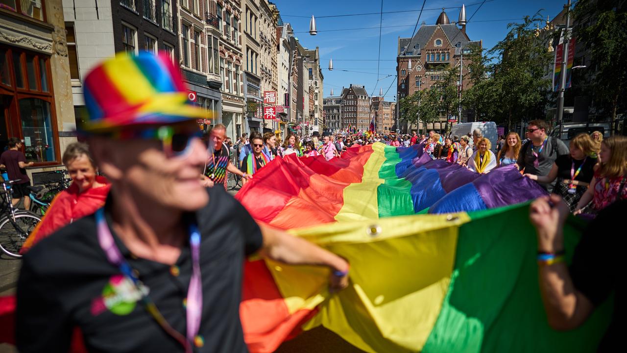 Pride Parade participants walk through Amsterdam on the first day of the Amsterdam Pride Festival.
