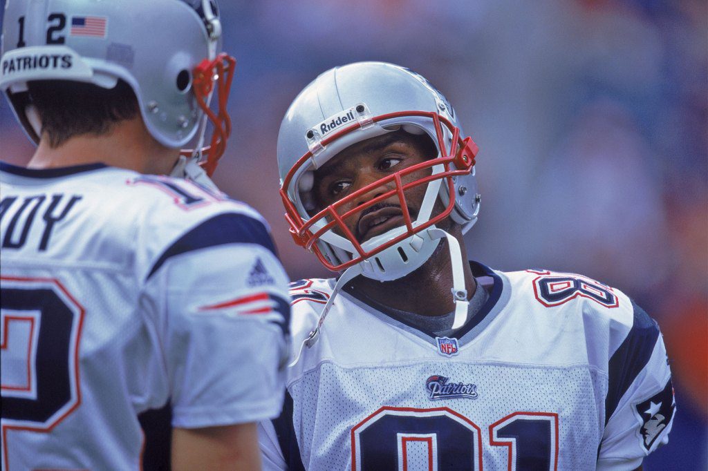 Charles Johnson and Tom Brady have a conversation during a game against the Denver Broncos at Invesco Field on October 28, 2001. 