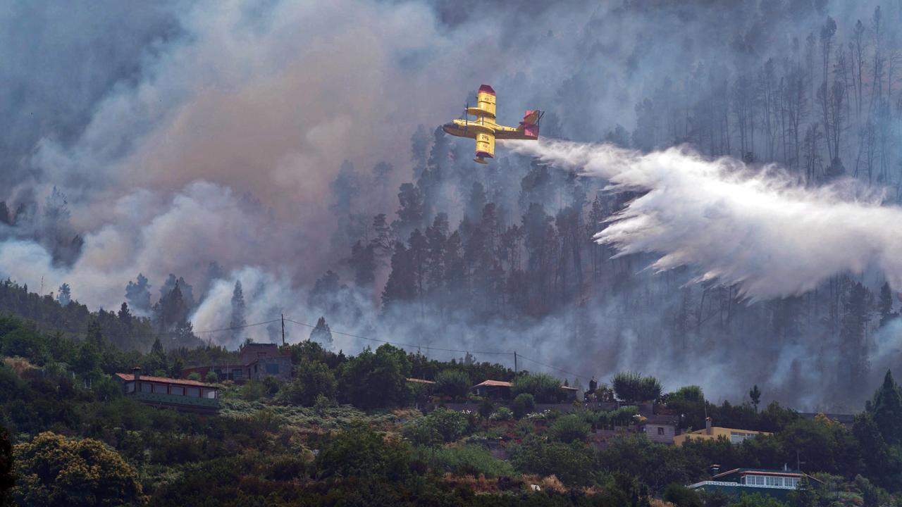 A firefighting plane over a forest fire in Tenerife, Spain