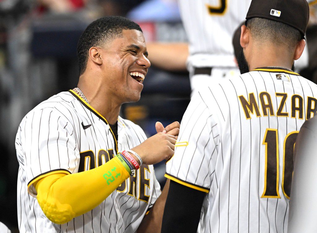 Juan Soto shares a laugh with his new teammate Nomar Mazara during the Padres win. 