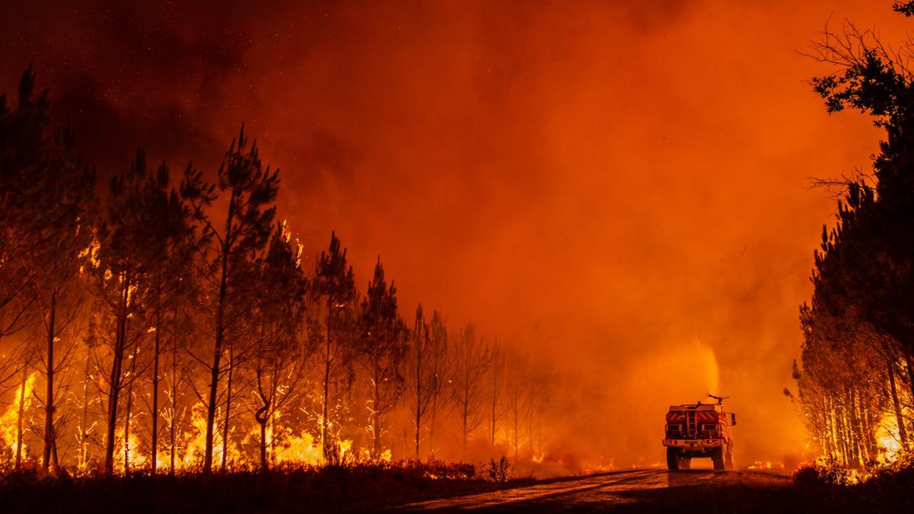 A firetruck operates during a forest fire in the Gironde.