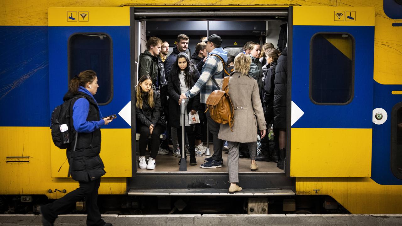 Travelers try to get a seat on a full train during the morning rush hour on October 11th at Utrecht Central Station.