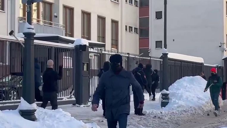 The video shows masked men throwing hammers at the wall of the Finnish Embassy in Moscow.  picture 