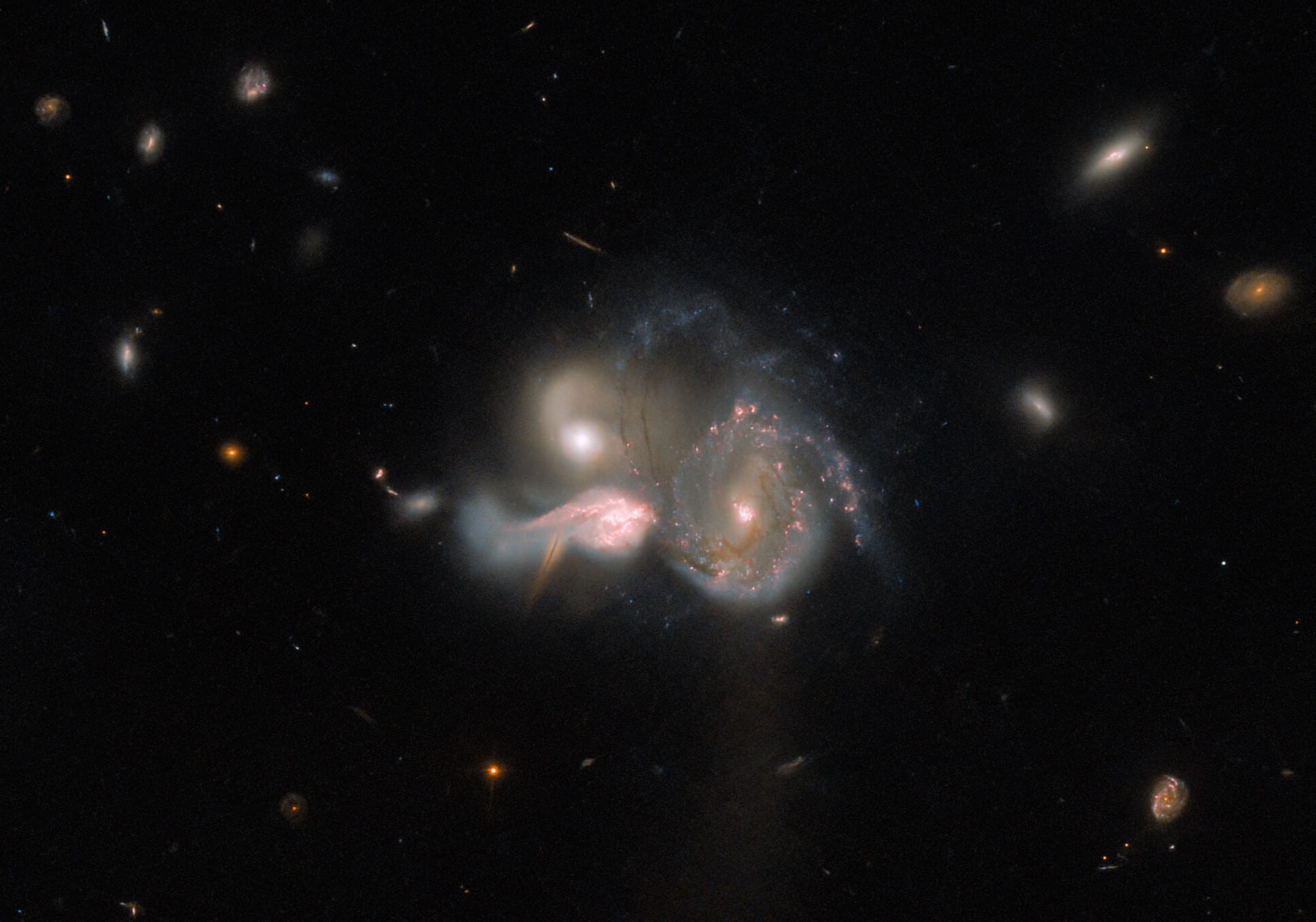 Three galaxies on a collision course: a rare event