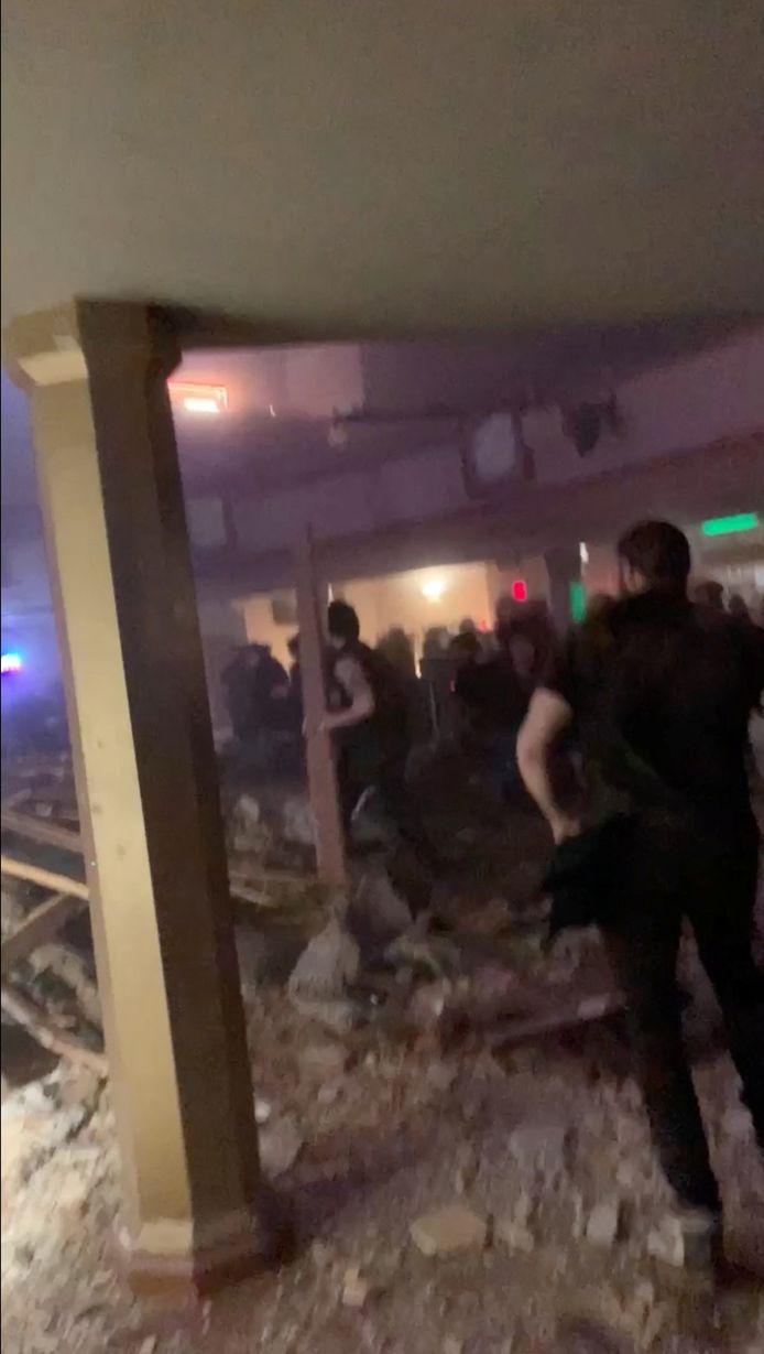 People search for an exit from the collapsed concert hall amid the rubble, a picture shared on social media.