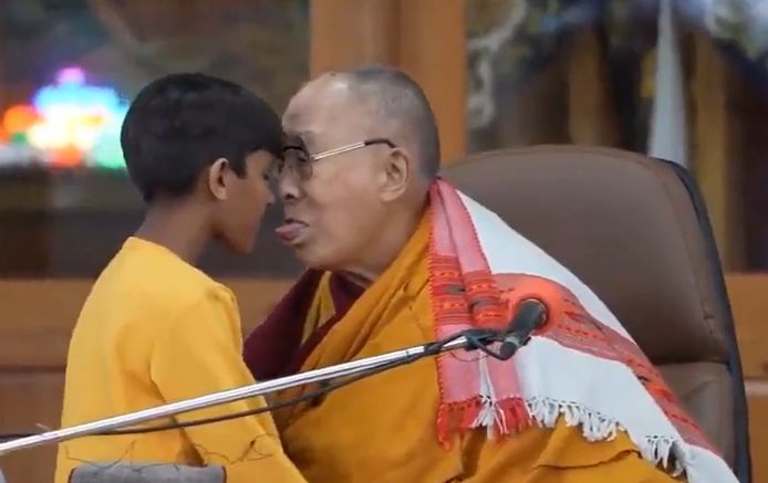 The Dalai Lama asks the boy to suck his tongue.