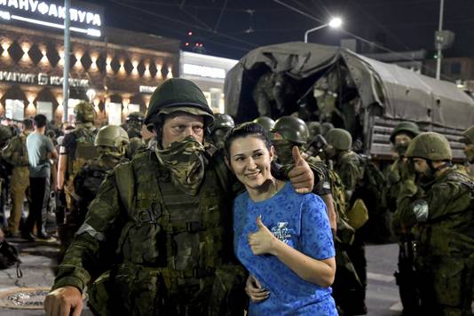 Civilians stand with Wagner fighters in Rostov.