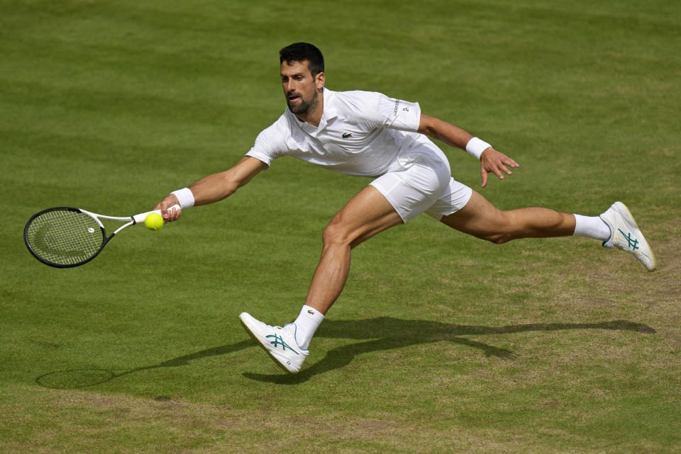 Serbia's Novak Djokovic holds Spain's Carlos Alcaraz back in the men's singles final on day 14 of the Wimbledon Tennis Championships in London, Sunday, July 16, 2023 (AP Photo/Alastair Grant)