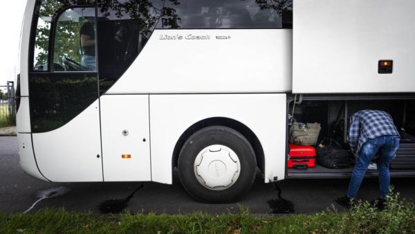 The German driver returns home and leaves the bus full of elderly people next to the highway  outside