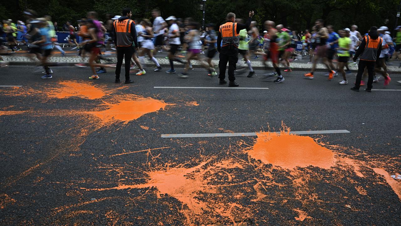 Police prevent climate protesters from disrupting the start of the Berlin Marathon  outside