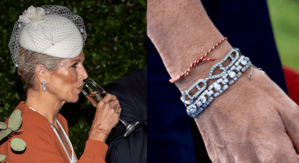 Why does Maxima wear a red and white string around her wrist?