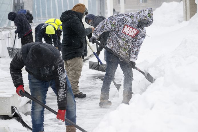 Workers clear snow in Des Moines, Iowa on January 13, 2024.