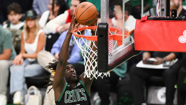 June 9, 2024;  Boston, Massachusetts, USA;  Boston Celtics guard Jrue Holiday (4) dunks and scores against the Dallas Mavericks during the second half of Game 2 of the 2024 NBA Finals at TD Garden.  Mandatory Credit: USA TODAY Sports Images