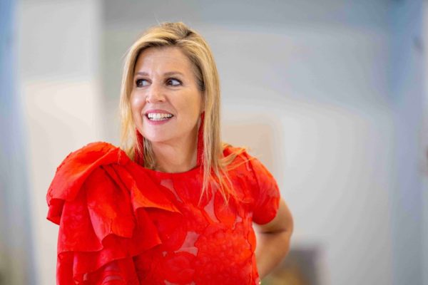 Maxima wears a bright red blouse in Friesland